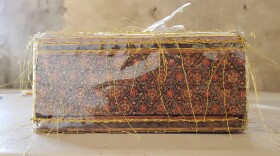In a May 2020 art work in progress by Nassem Navab, a decorative tissue box is wrapped in clear plastic vinyl and stitched with gold thread.