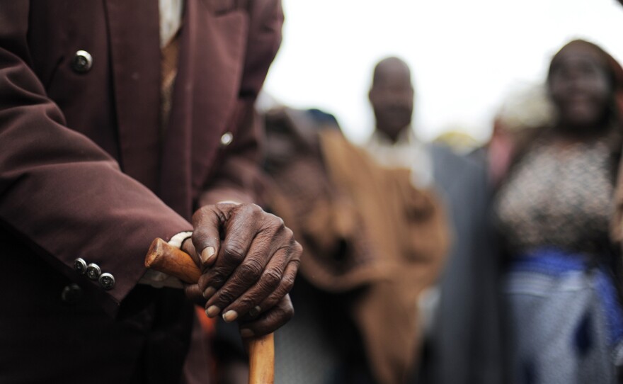 A Kenyan senior citizen leans on his cane. As people age in parts of Africa, they report declining levels of satisfaction with their life.
