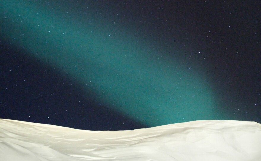 The Northern Lights over the town of Ittoqqortoormiit, Greenland — about 400 miles north of the Arctic Circle.