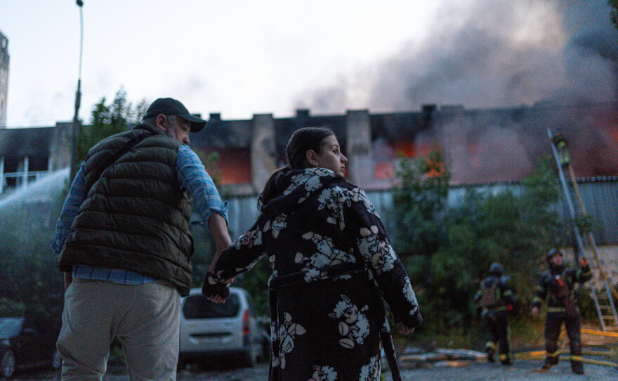 People gather outside after the night attack in Kyiv, Ukraine.