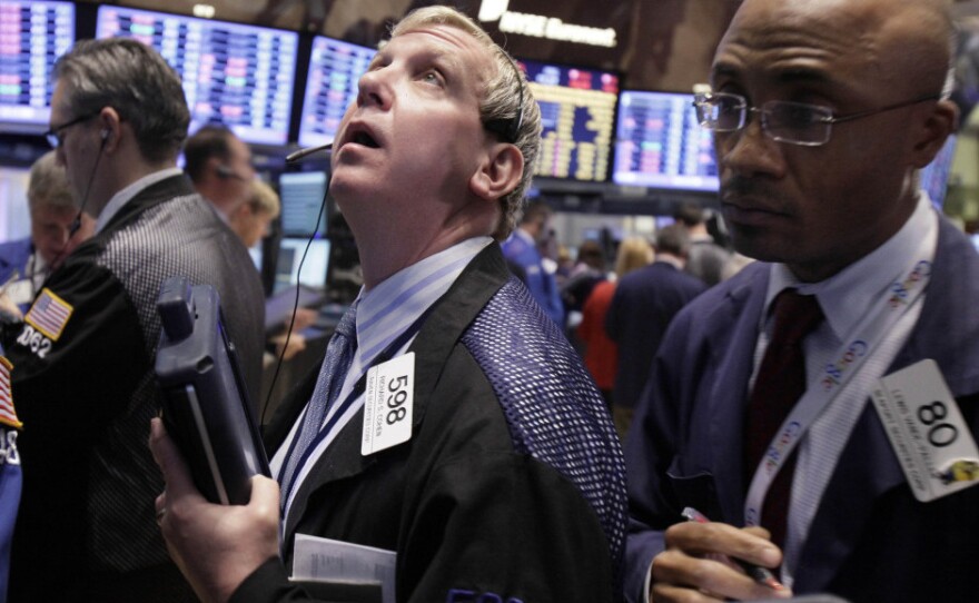 Traders Richard Cohen (left) and Lewis Vande-Pallen work on the floor of the New York Stock Exchange on Nov. 21.