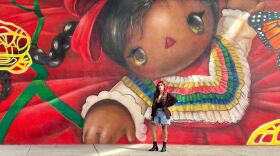 Michelle Guerrero (Mr. B Baby) poses in front of her mural on Beyer Blvd. on Sept. 22, 2025 in San Diego, Calif.