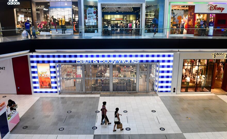 Shoppers stroll through the newly reopened Westfield Santa Anita mall in Arcadia, Calif., on Oct. 7.
