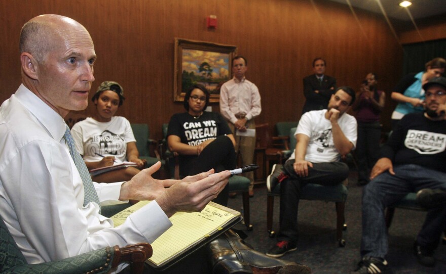 Florida Gov. Rick Scott speaks to protesters Thursday in the Capitol in Tallahassee. Scott told the protesters that he won't ask lawmakers to revamp the state's controversial self-defense law.