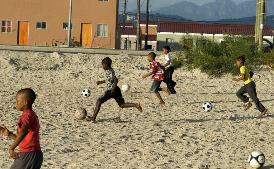 Children dribble soccer balls in Blikkiesdorp -- Afrikaans for "Tin Can City" -- a settlement of corrugated metal shanties east of Cape Town, South Africa. In the run-up to the World Cup, the government has moved many of Cape Town's homeless to Blikkiesdorp. Similar actions are taking place across the country.