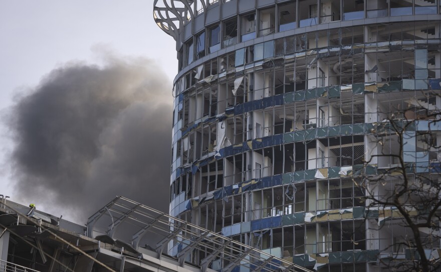Kyiv: Smoke rises behind a building damaged in Russia's missile attack.