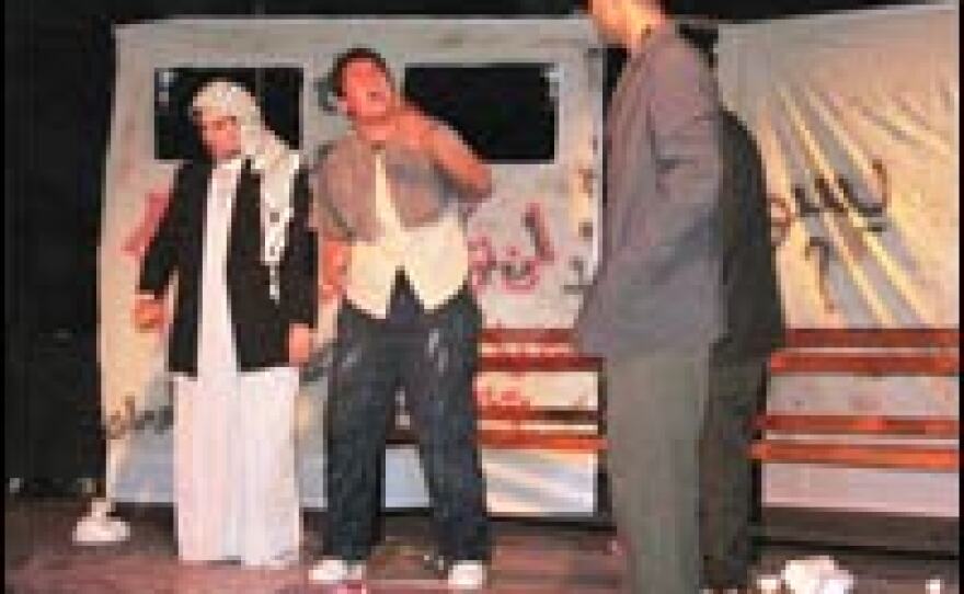 Actors perform "The Journey" on the stage at Freedom Theatre.
