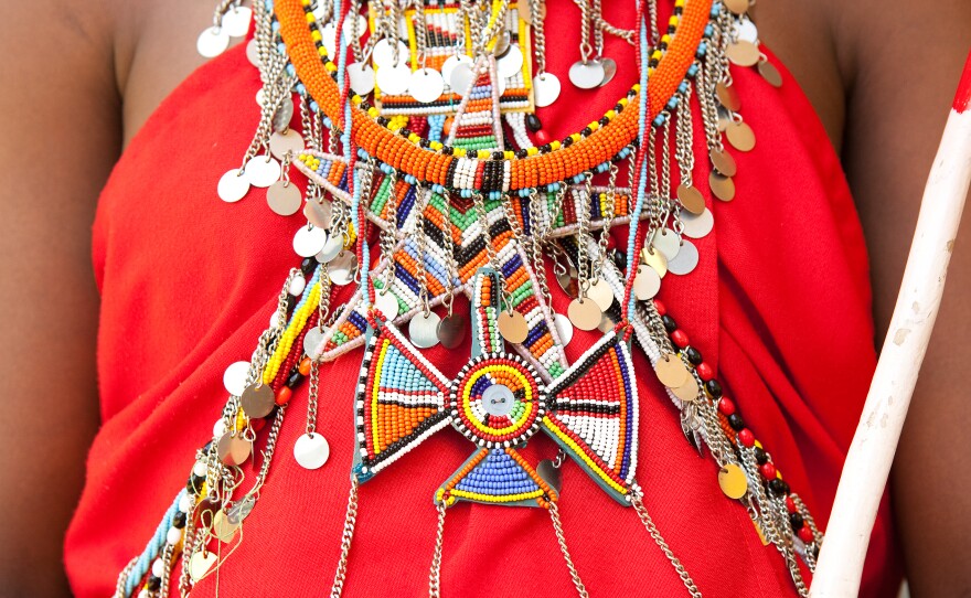 The Maasai wear vibrant colored shukas, or robes, adorned with elaborate beaded jewelry made by the women.