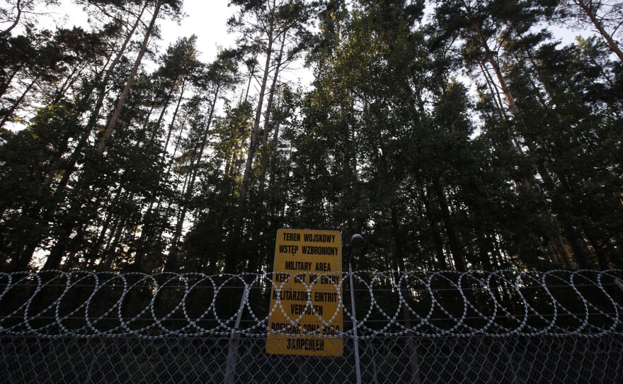 Barbed-wire fence surrounding a military area is pictured in the forest near Stare Kiejkuty village, close to Szczytno in northeastern Poland. The CIA ran a secret jail on Polish soil, the European Court of Human Rights ruled Thursday.