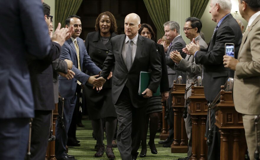 Calif., Gov. Jerry Brown is greeted by lawmakers as he enters the Assembly to deliver his annual State of the State address to a joint session of the state Legislature Tuesday, Jan. 24, 2017, in Sacramento, Calif.