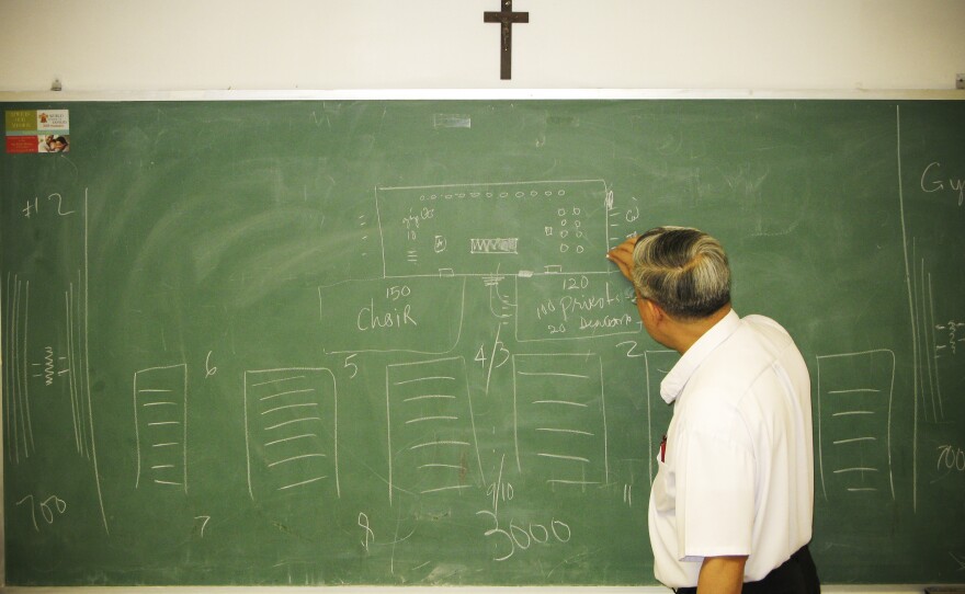 The Rev. Joseph Trinh, the senior priest at St. Helena, meets with the liturgy and decorations committee planning a Mass for Vietnamese Catholics during Pope Francis' visits to the city later this month.
