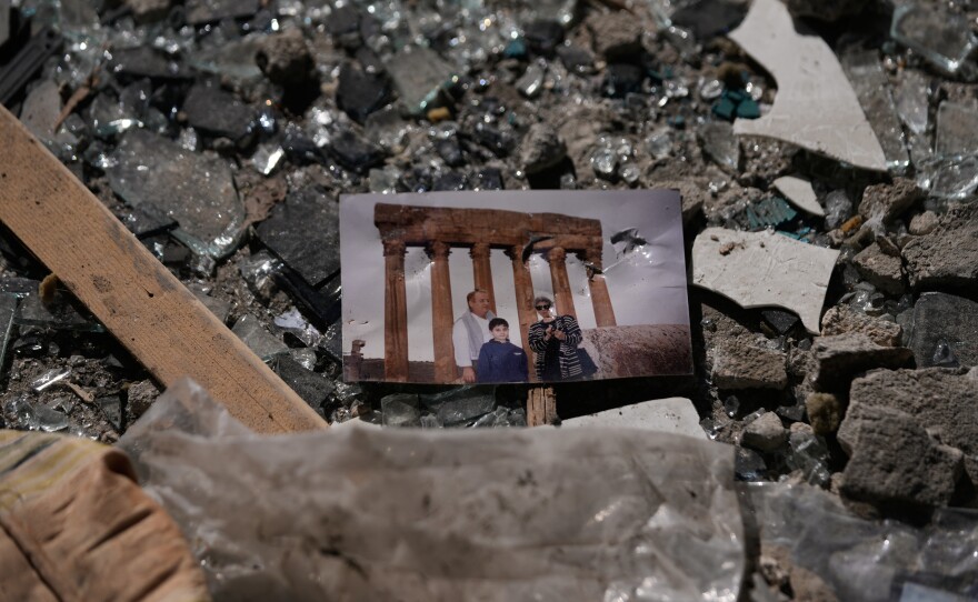 A family picture sits in the rubble at the site of a destroyed building that was hit a day ahead in an Israeli airstrike in central Beirut, Lebanon, Thursday, April 9, 2026.