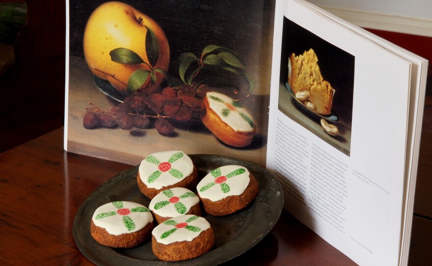 Cakes displayed with a reproduction of Raphaelle Peale's Still Life with Cake, from circa 1822.