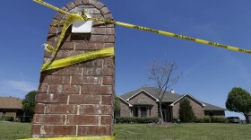 Crime scene tape is seen outside the home of Kaufman County District Attorney Mike McLelland. McLelland and his wife Cynthia were murdered at their home March 30, 2013.