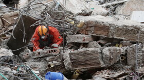 A Mexican rescue worker searches through the rubble two days after an earthquake struck Cali, Colombia, Wednesday, Aug. 12, 2026.