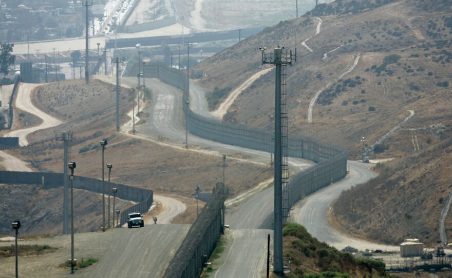 A U.S. Border Patrol vehicle is stationed between the primary and secondary fences along the U.S.-Mexico border in San Diego, July 20, 2008.