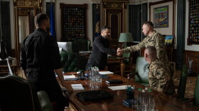 In this photo provided by the Ukrainian Presidential Press Office, Ukrainian President Volodymyr Zelenskyy, center, shakes hands with new commander-in-chief of Ukraine's Armed Forces Mykhailo Drapatyi during their meeting in Kyiv, Ukraine, Monday, July 20, 2026. (Ukrainian Presidential Press Office via AP)