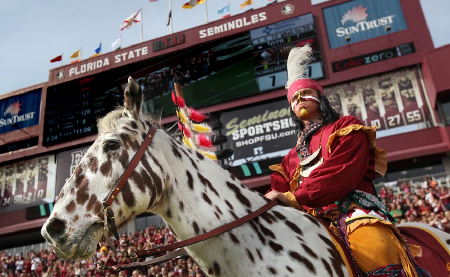 "Osceola" stands in front of a crowd at the FSU homecoming game.