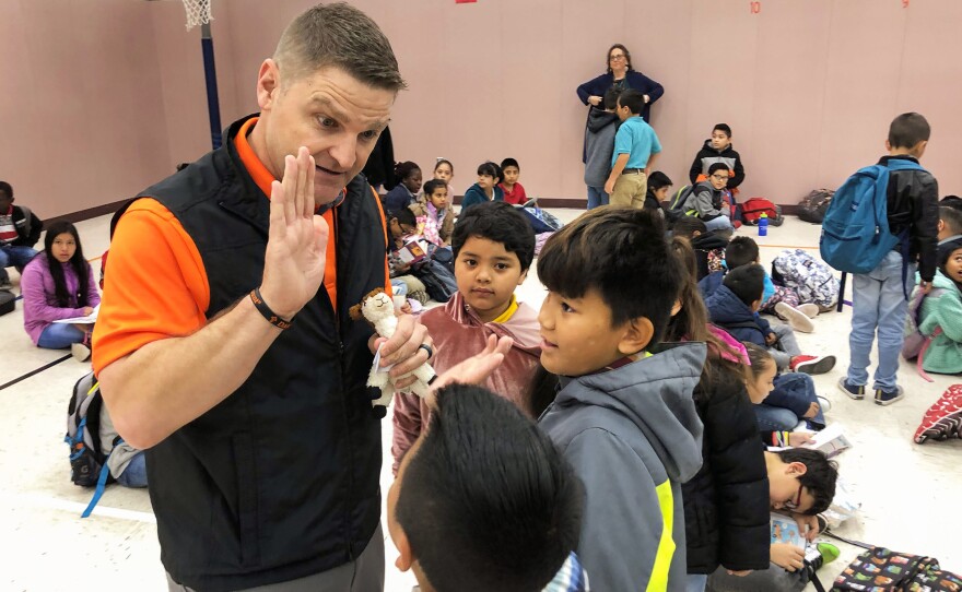 Principal T.J. Funderburg welcomes his mostly immigrant students during morning assembly at Cactus Elementary School.