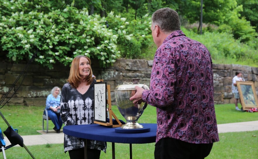 Grant Zahajko (right) appraises a Whiting Silver Billiards Trophy and Illustration, in Bentonville, Ark. ANTIQUES ROADSHOW “Junk in the Trunk 14!” airs Monday, May 19 at 8/7C PM on PBS.