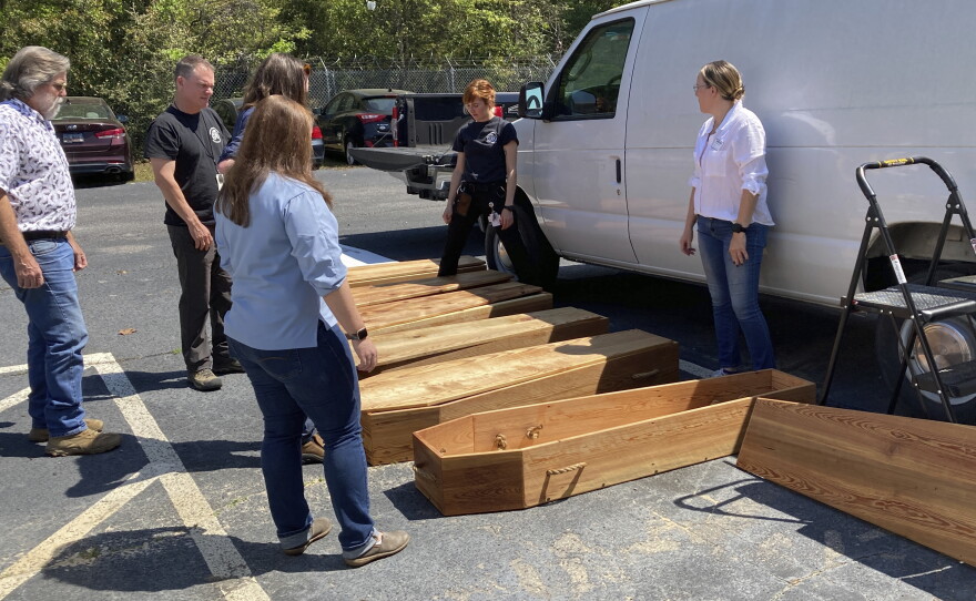 Forensic anthropologists, archeologists and volunteers prepare homemade coffins for the remains of unidentified Revolutionary War soldiers killed in the Battle of Camden in 1780 for reburial on Thursday, March 30, 2023, in Columbia, South Carolina. The remains were removed from the battlefield, studied and analyzed and will be buried in a ceremony.