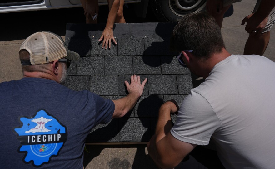 Members of Project ICECHIP inspect shingles for hail damage during an operation last year in Morton, Texas.