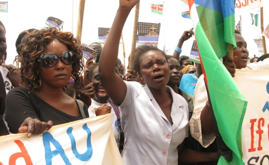 Student Gloria Emmanuel (center) speaks for many South Sudanese who claim Sudan, and its president, Omar Hassan Al Bashir, have declared war on the South.