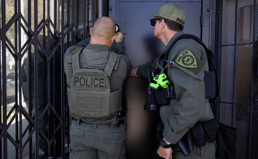 California Department of Cannabis Control detectives lock the premises after serving a search warrant on an unlicensed dispensary in Long Beach, Calif., on March 5, 2024. The penalty for unlicensed cannabis sales is usually a fine, and officers raid the some addresses over and over.