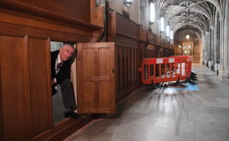 Speaker of the U.K. House of Commons Lindsay Hoyle emerges from a chamber concealing a 360-year-old passageway that was rediscovered during renovation work in the Houses of Parliament in London.