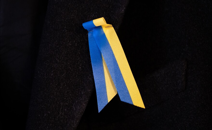 Toomas Hendrik Ilves wears a ribbon pin in support of Ukraine.