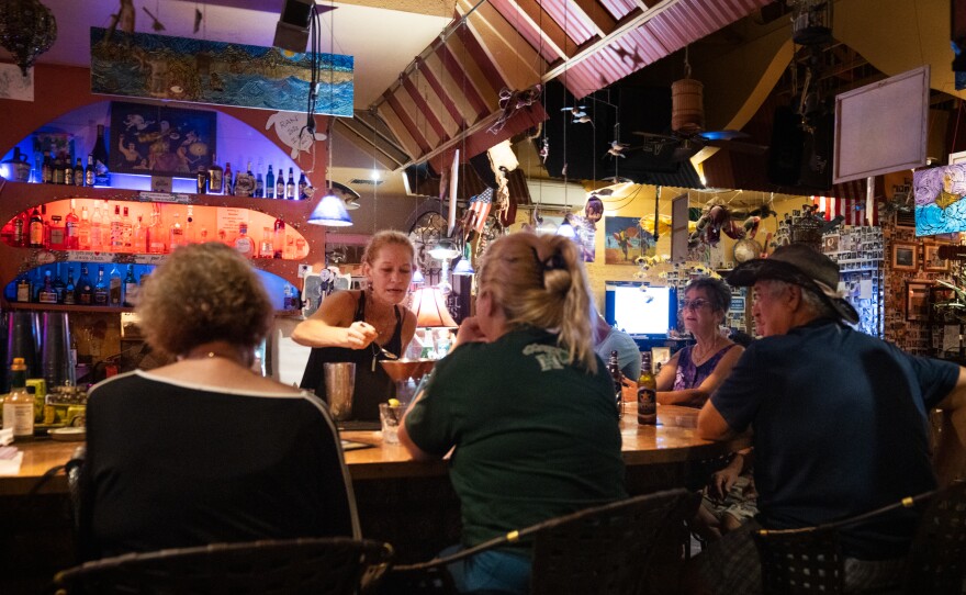 Cori Gross, bartender at Java Jazz, greets residents with bursts of joy to see that they've survived the fires.