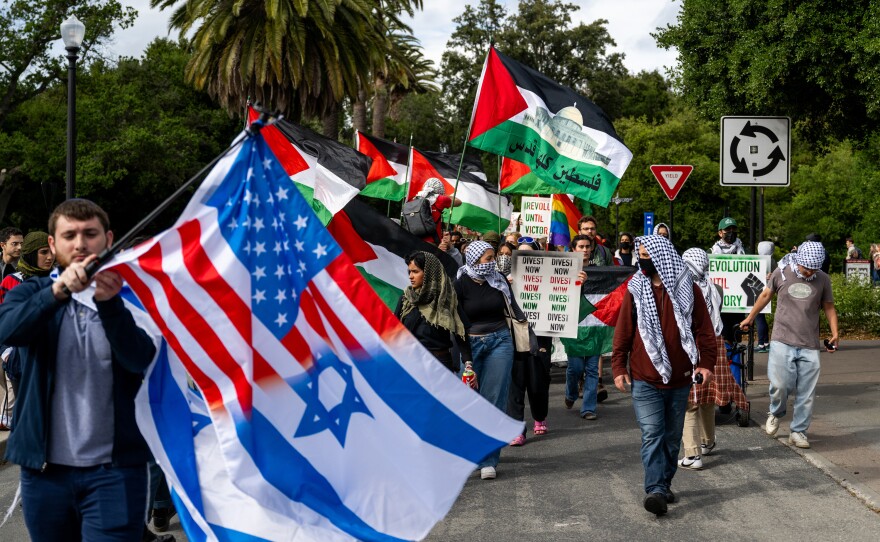 A pro-Israel counter-protester waves an Israel flag during a pro-Palestinian march through the Stanford University campus in Stanford, Calif., on April 25, 2024, calling for the university to divest from Israel. The rally took place during Stanford's Admit Weekend, a time for incoming students to tour the university.