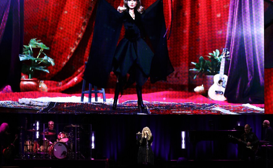 Stevie Nicks stands under an image of her new Barbie doll during a concert at New York City's Madison Square Garden on Sunday.