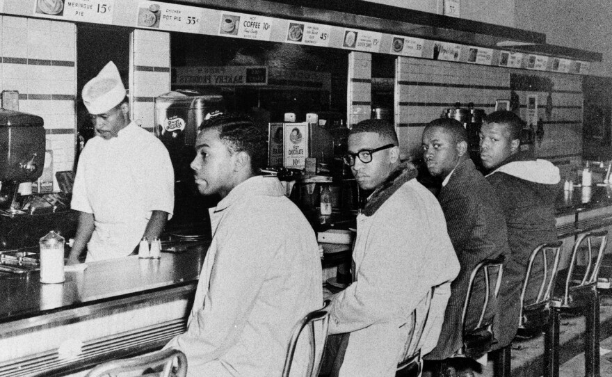 (From left)Joseph McNeil and Franklin McCain, two of the Greensboro Four, and Billy Smith and Clarence Henderson sit without being served at the luncheon counter of F.W. Woolworth Co.