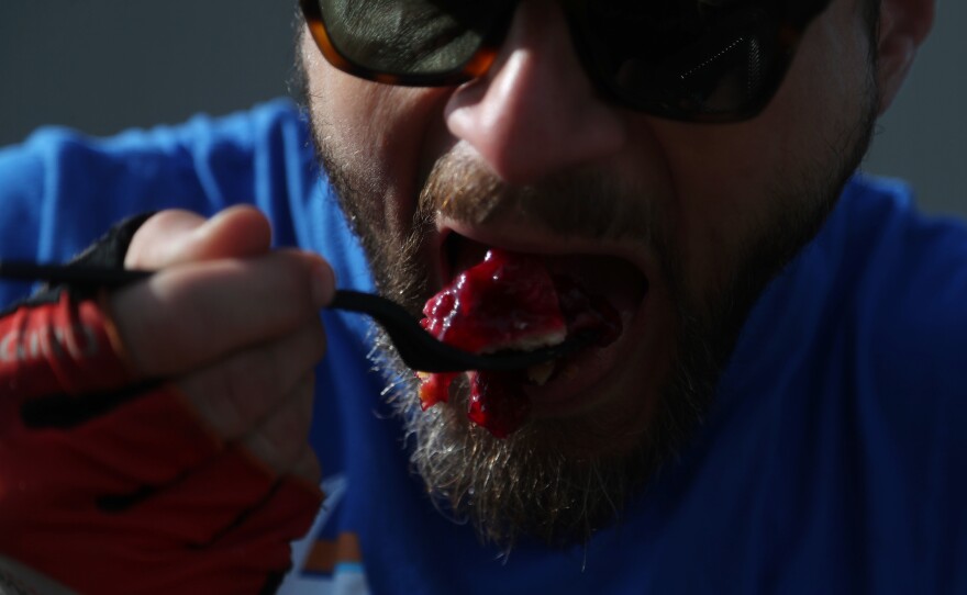 Alex Brooks of Minneapolis, Minn., takes a bite of his cherry pie Tuesday, July 26, during a pit stop in Rolfe, Iowa.