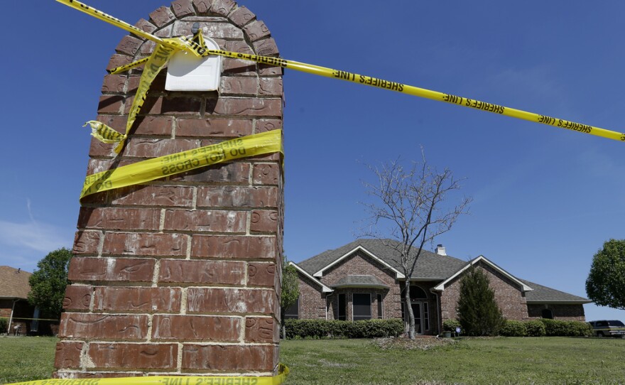 Crime scene tape is seen outside the home of Kaufman County District Attorney Mike McLelland. McLelland and his wife Cynthia were murdered at their home March 30, 2013.