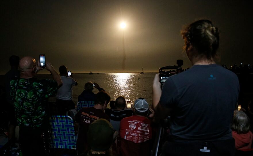 People at Veterans Memorial park watch as the Artemis I unmanned lunar rocket lifts off at NASA's Kennedy Space Center, on Nov. 16 in Titusville, Fla.