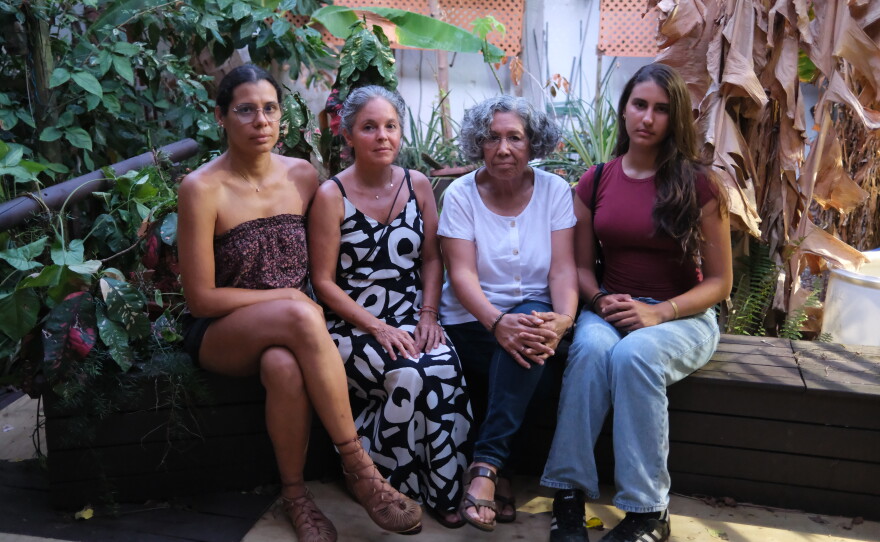 Yoamadil Cabán, Norma Peña, Sonia Palacios and Polyana Cabán — neighbors in San Juan who've had to settle into new and frustrating routines after a year of unreliable water service.