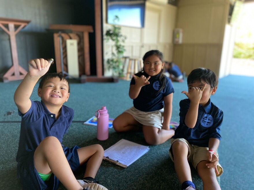 Displaced students from the Sacred Hearts School in Lahaina, Hawaii, are learning in temporary locations that include churches, covered parking lots, and hotel spaces as seen in this undated photo.