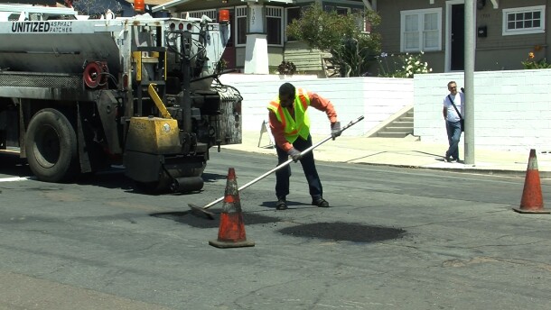 A San Diego worker fills a pothole in the South Park neighborhood on April 29, 2014.