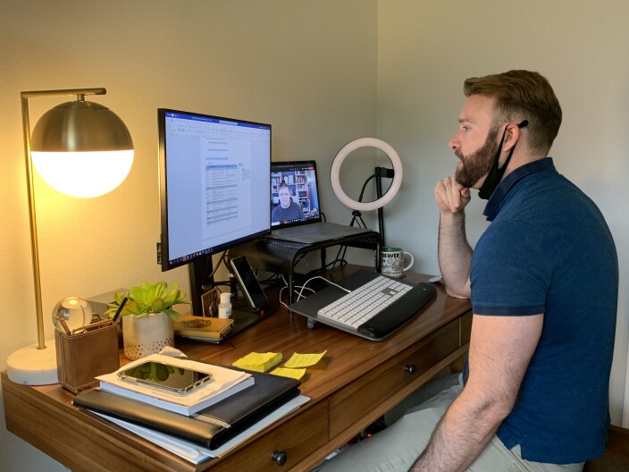 Andrew Picard looks at his computer during a virtual meeting with a colleague while working from home, March 3, 2021.