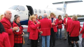 Dignitaries in Hot Springs, Ark., prepare to cut the ribbon to inaugurate Seaport Airlines' new service to Memphis. The company is flying three daily non-stop flights on a nine passenger propeller plane, with financial support from the federal government.