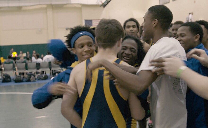 The J.O. Johnson Jaguars bring it in for a group hug to celebrate a big win.