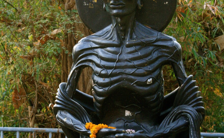A statue depicts an emaciated Buddha, who denied himself food as a form of asceticism before finding enlightenment.