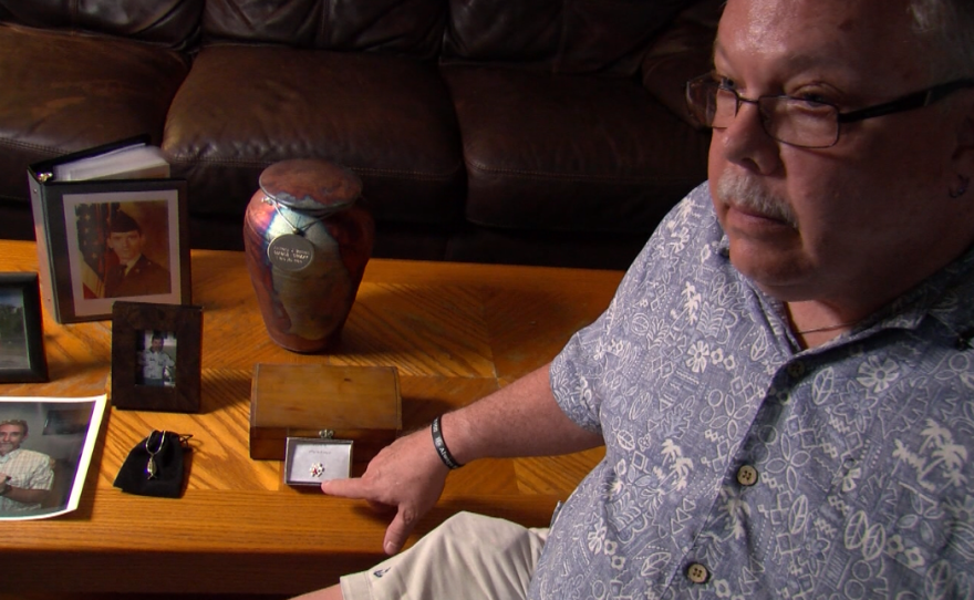 Blake Miller is surrounded by mementos of his recently deceased partner, Anthony Bennett, in this photo, Aug. 22, 2017.