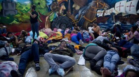 Honduran migrants rest at the border between Guatemala and Mexico, in Tecun Uman, Guatemala, Friday, Oct. 19, 2018.