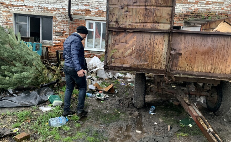 Valerii Kyselov, 36, walks past discarded meal packs near the barn where Russian soldiers slept in Bilka, Ukraine.