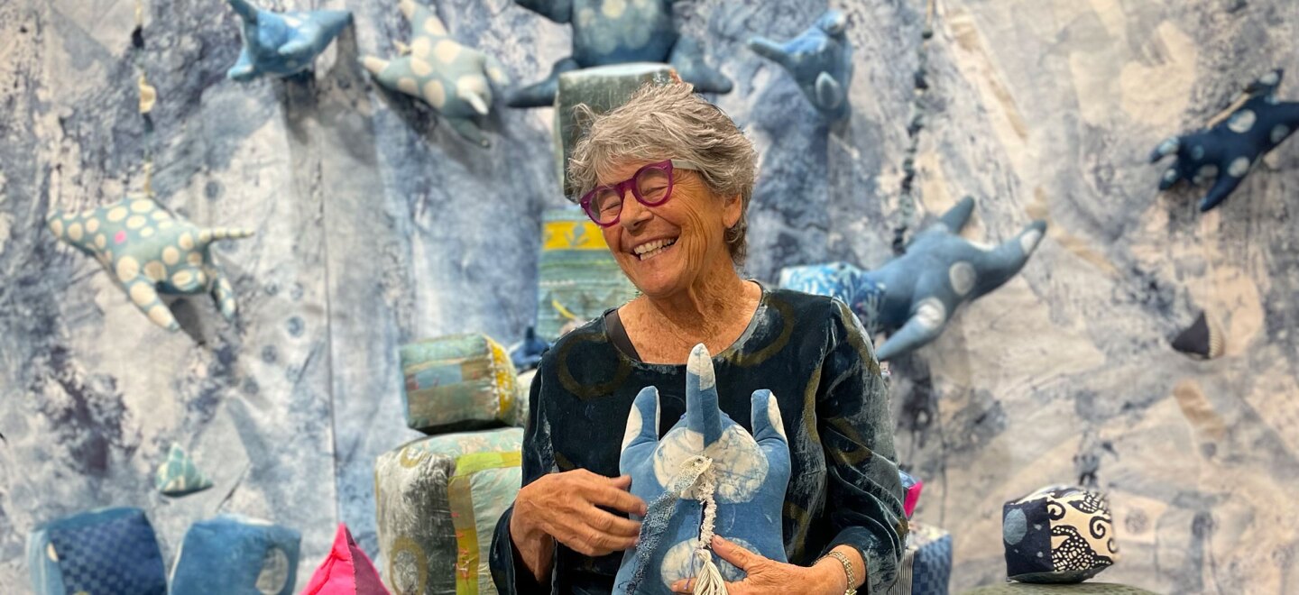 Artist, educator and printmaker Sibyl Rubottom is pictured with textile work from her exhibition at the Athenaeum Art Center in Logan Heights, San Diego, Nov. 12, 2022. Rubottom will retire from her role managing the AAC's Print Studio in Jan. 2023.
