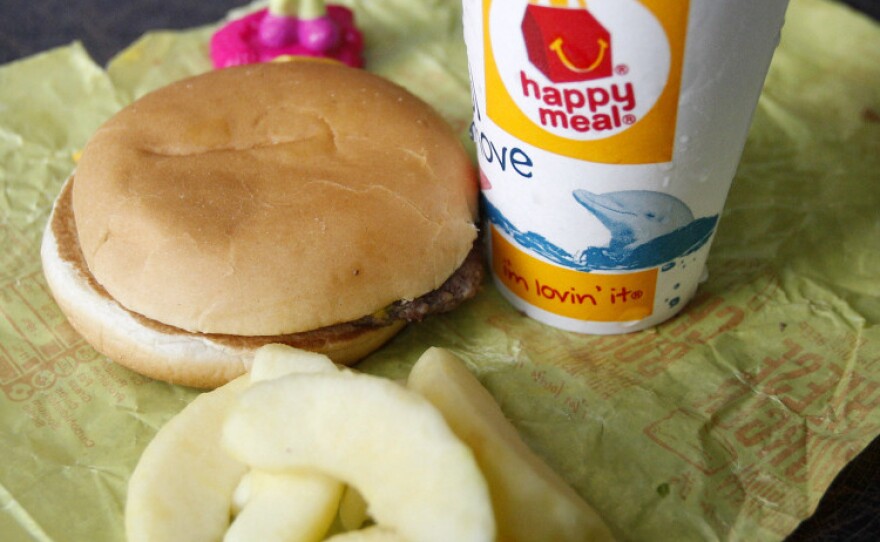 A McDonald's Cheeseburger Happy Meal with the new apple slices option is shown Tuesday. McDonald's Corp. says it is adding apple slices to every Happy Meal, part of the chain's larger push to paint itself as a healthy place to eat.
