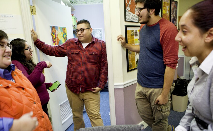 Lacey Williams (from left), Mary Espinosa, Jaime Villegas, Armando Cruz Martinez and Elisa Benitez talk inside the offices of the Latin American Coalition in Charlotte, N.C. According to a 2011 Pew Hispanic report, the median age of Latinos in North Carolina is 24.